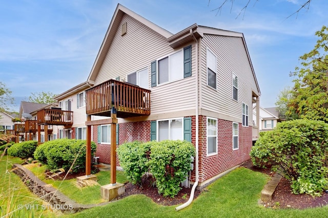 196 Tyler Ct, Lake Zurich, IL 60047 - back of property with brick siding, a balcony, and a yard