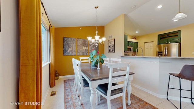196 Tyler Ct, Lake Zurich, IL 60047 - dining area featuring lofted ceiling, a chandelier, light tile patterned flooring, and recessed lighting