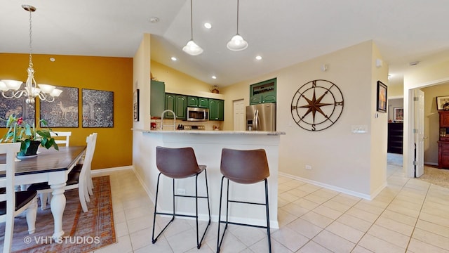 196 Tyler Ct, Lake Zurich, IL 60047 - kitchen featuring green cabinets, stainless steel appliances, a peninsula, light countertops, and a kitchen bar