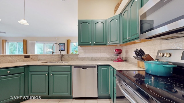 196 Tyler Ct, Lake Zurich, IL 60047 - kitchen featuring stainless steel appliances, a sink, backsplash, light stone countertops, and green cabinetry
