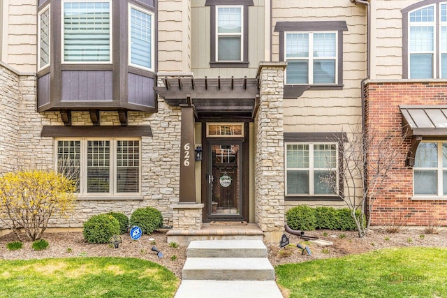 doorway to property featuring stone siding