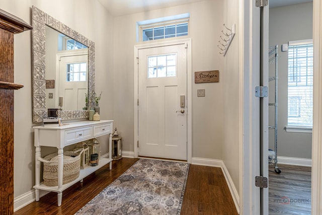 entryway featuring baseboards and dark wood-style flooring