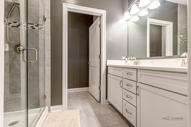 full bathroom featuring tile patterned floors, vanity, and a stall shower