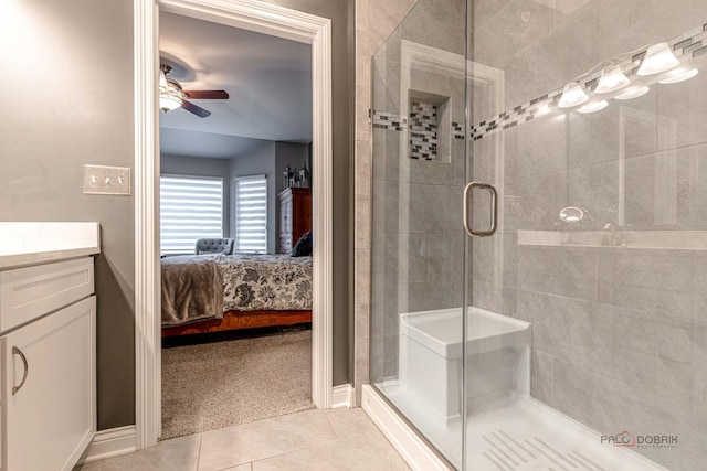 bathroom with tile patterned flooring, a ceiling fan, vanity, connected bathroom, and a stall shower