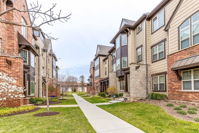 view of home's community with a lawn and a residential view