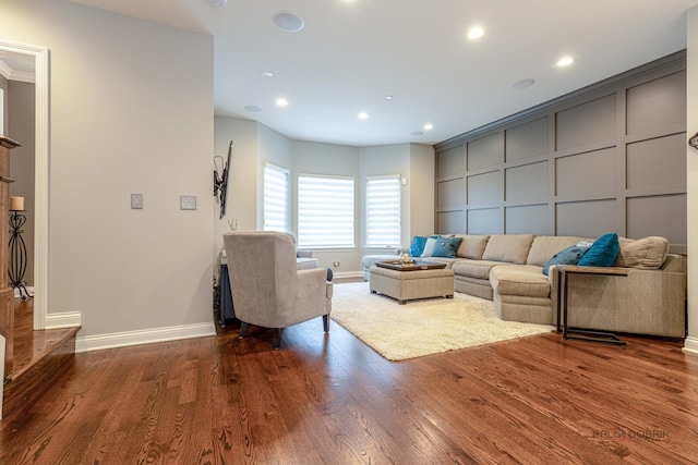 living room with dark wood finished floors, baseboards, and recessed lighting