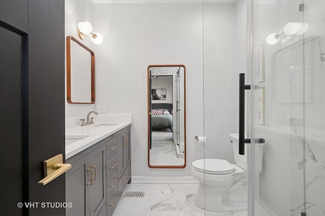 ensuite bathroom with a sink, a marble finish shower, double vanity, and marble finish floor