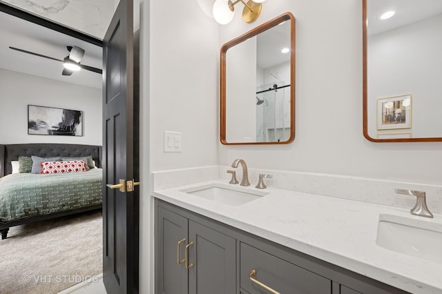 full bathroom featuring double vanity, a shower with door, a sink, and ensuite bath