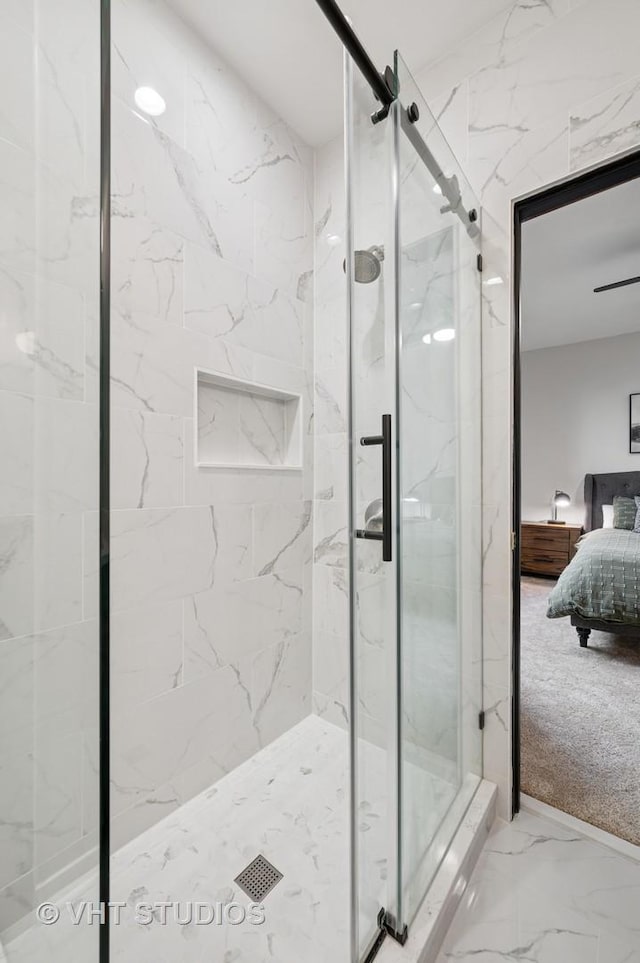 ensuite bathroom featuring ensuite bathroom, marble finish floor, and a marble finish shower