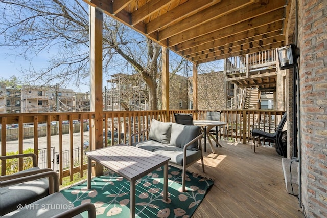 wooden deck with stairs and outdoor lounge area