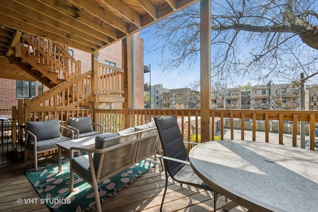 wooden deck with an outdoor hangout area, stairs, outdoor dining area, and a residential view