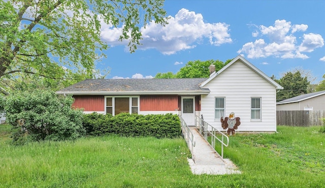 view of front of property with a chimney and fence