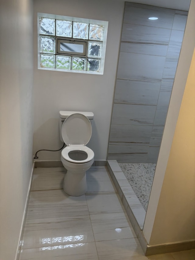 12449 S Union Ave, Chicago, IL 60628 - bathroom with toilet, tile patterned flooring, a stall shower, and baseboards
