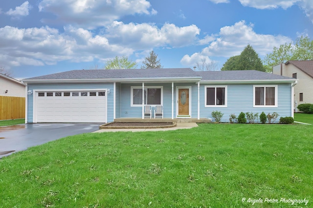 ranch-style house featuring covered porch, a front yard, an attached garage, and driveway