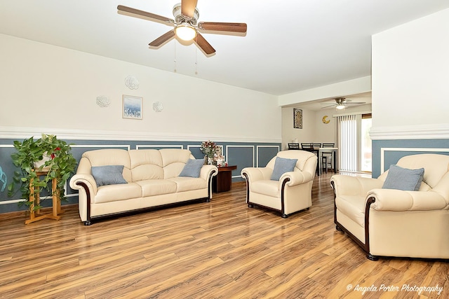 living area with light wood-type flooring and a ceiling fan