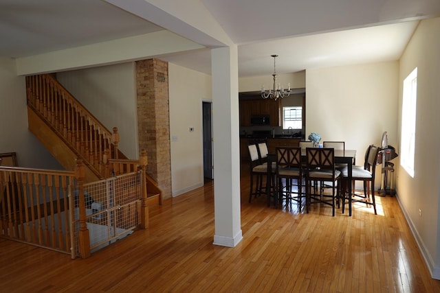 11108 S Myrtle St, Huntley, IL 60142 - dining area featuring a chandelier, hardwood / wood-style floors, baseboards, and stairs