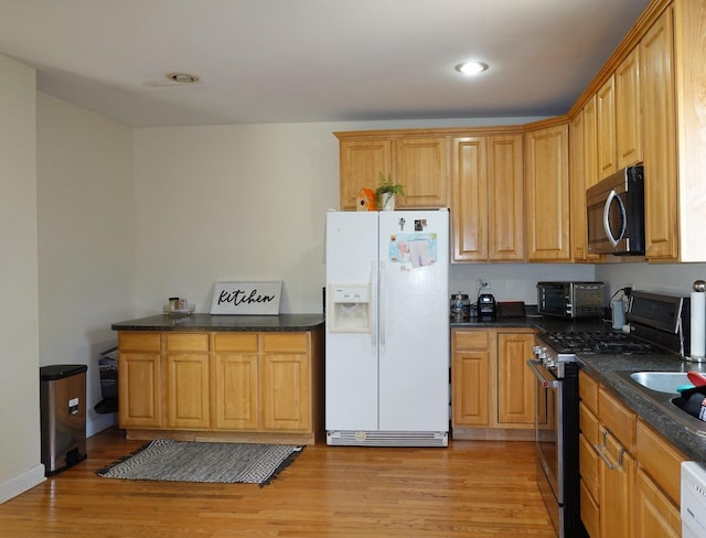 11108 S Myrtle St, Huntley, IL 60142 - kitchen featuring appliances with stainless steel finishes, light wood finished floors, recessed lighting, and dark stone countertops