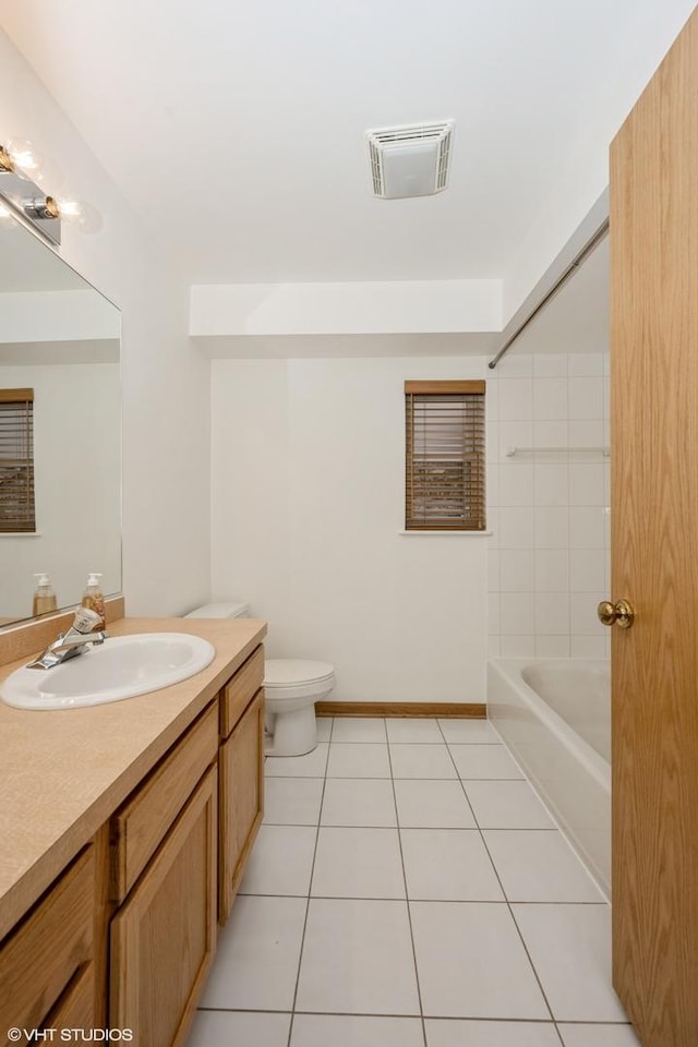 full bathroom with tile patterned floors, toilet, vanity, and washtub / shower combination