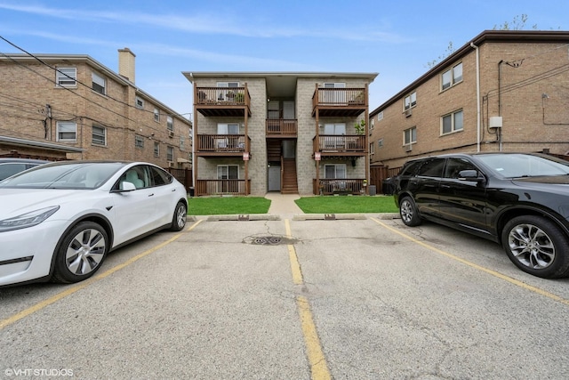 view of building exterior with uncovered parking