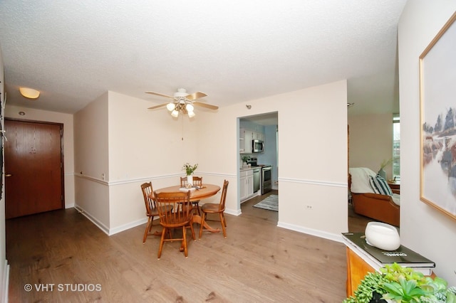 1285 Luther Ln Unit 369B, Arlington Heights, IL 60004 - dining space featuring a textured ceiling, baseboards, a ceiling fan, and wood finished floors