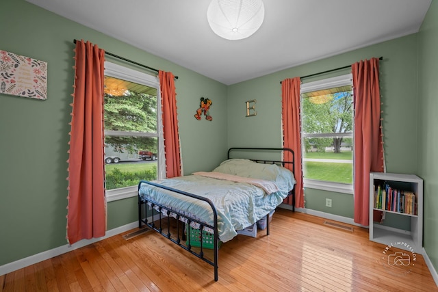 17 S Cypress Dr, Bristol, IL 60512 - bedroom featuring wood-type flooring, multiple windows, and baseboards