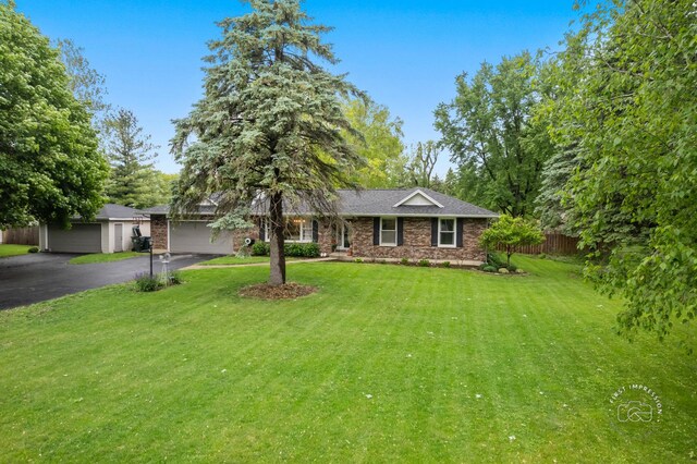 17 S Cypress Dr, Bristol, IL 60512 - single story home with asphalt driveway, brick siding, and a shingled roof