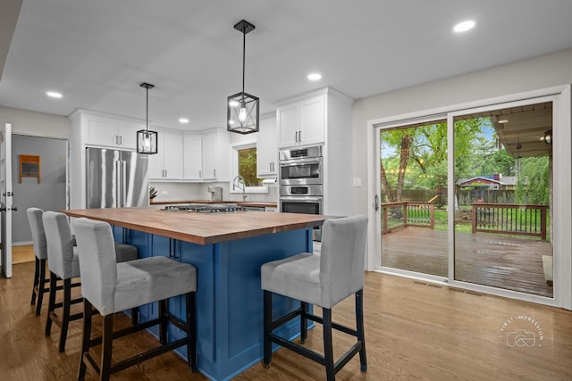 17 S Cypress Dr, Bristol, IL 60512 - kitchen featuring wood counters, white cabinets, appliances with stainless steel finishes, wood finished floors, and recessed lighting