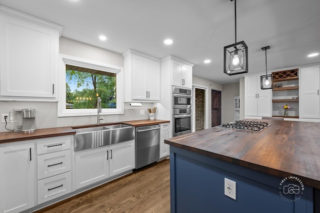 17 S Cypress Dr, Bristol, IL 60512 - kitchen with butcher block countertops, stainless steel appliances, a sink, dark wood-type flooring, and white cabinets