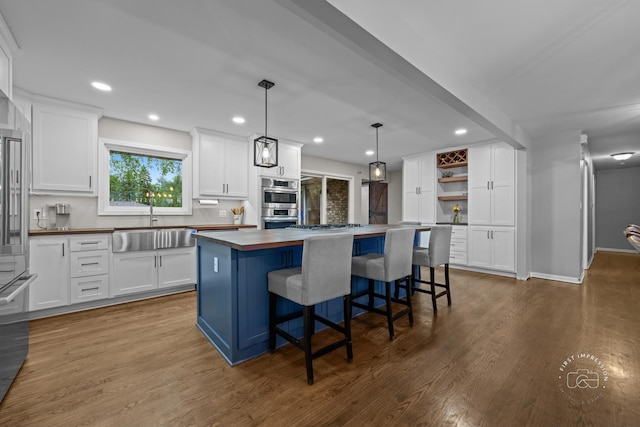 17 S Cypress Dr, Bristol, IL 60512 - kitchen featuring a sink, a center island, white cabinets, dark wood finished floors, and recessed lighting