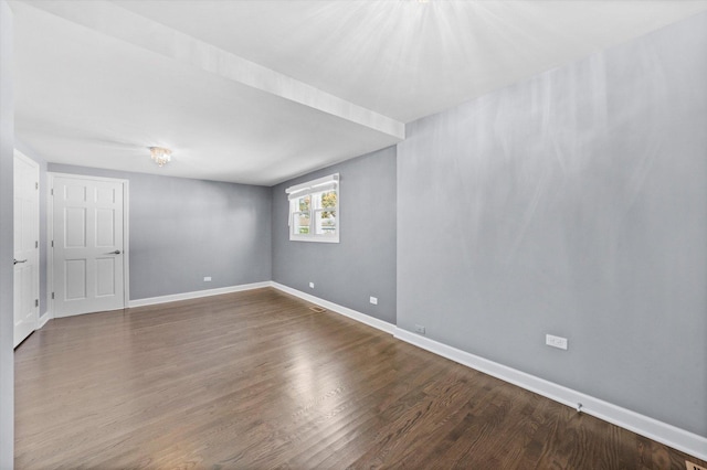 unfurnished room featuring wood finished floors and baseboards