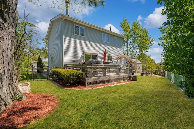 back of property with a wooden deck, an outbuilding, and a storage shed