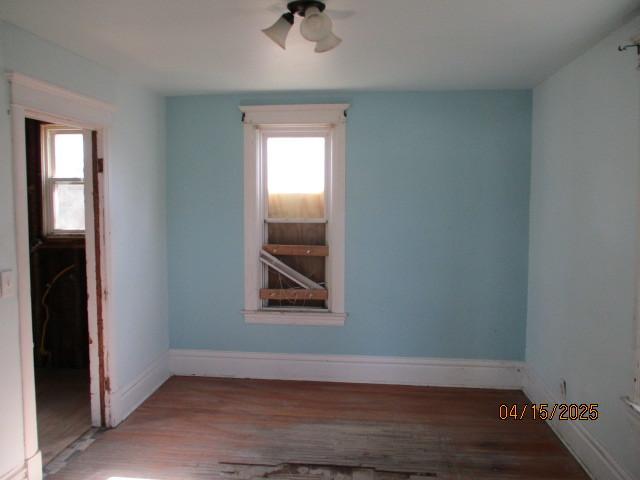 618 Napoleon St, Rockford, IL 61103 - empty room featuring wood finished floors, a healthy amount of sunlight, and baseboards