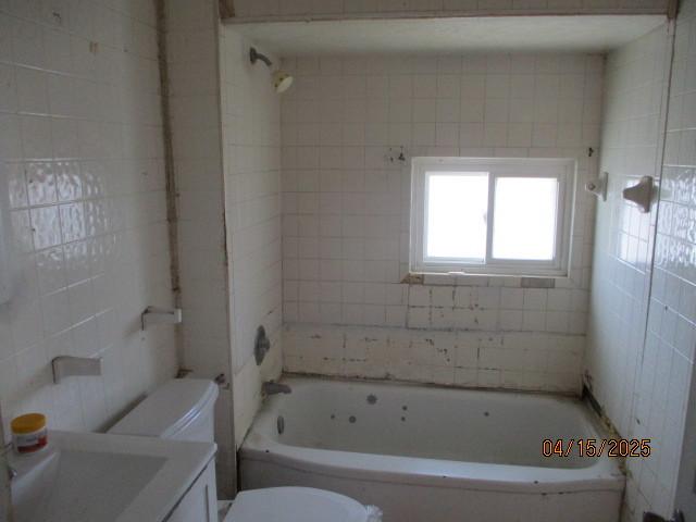 618 Napoleon St, Rockford, IL 61103 - bathroom featuring toilet, vanity, and  shower combination