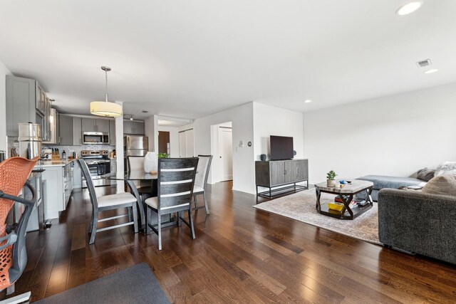 dining room with recessed lighting, dark wood finished floors, and visible vents