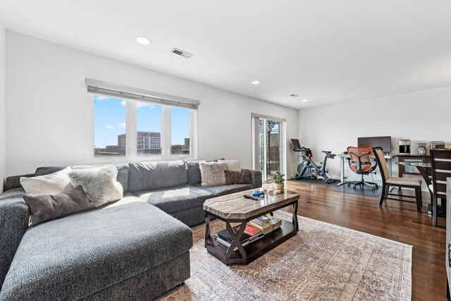 living area with recessed lighting, wood finished floors, and visible vents