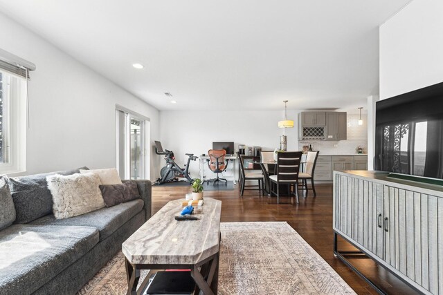 living room with recessed lighting and dark wood finished floors