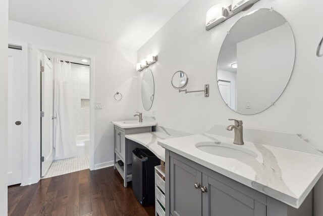 bathroom featuring vanity, baseboards, curtained shower, and wood finished floors