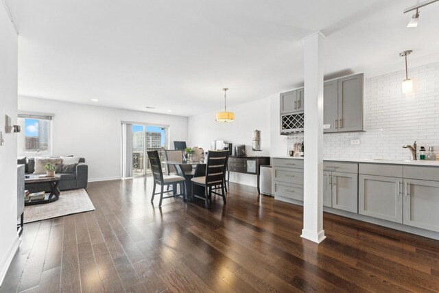 dining area featuring recessed lighting, baseboards, and dark wood-type flooring