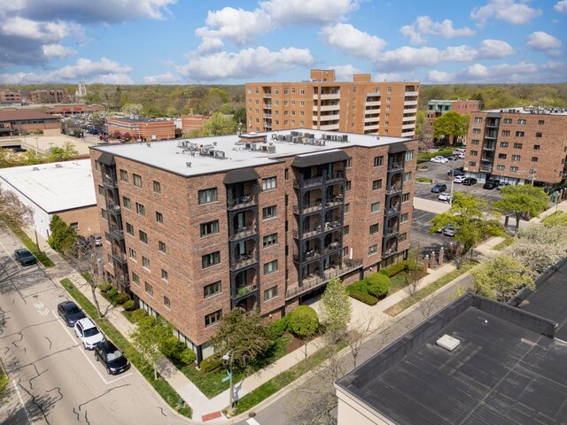 view of property with uncovered parking and central AC unit
