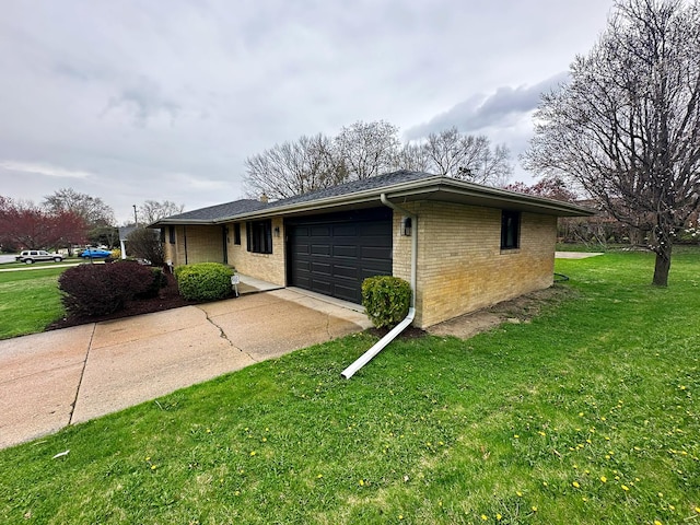 view of front of home featuring concrete driveway, brick siding, a front yard, and a garage
