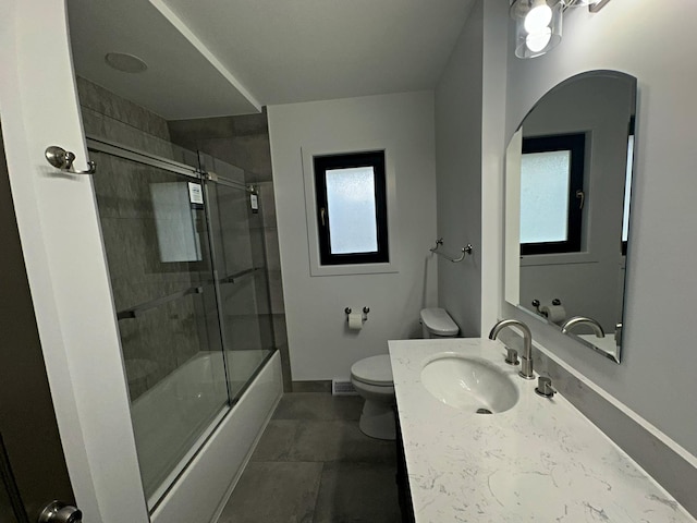 full bathroom with baseboards, toilet, shower / bath combination with glass door, and a healthy amount of sunlight
