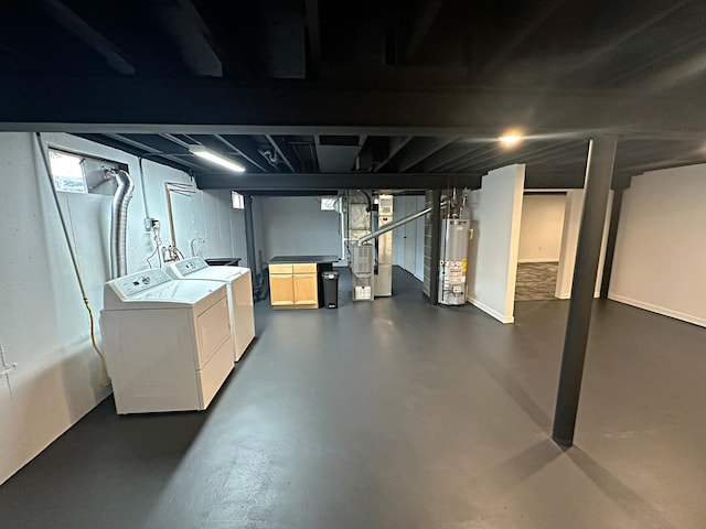 below grade area with separate washer and dryer, heating unit, and gas water heater