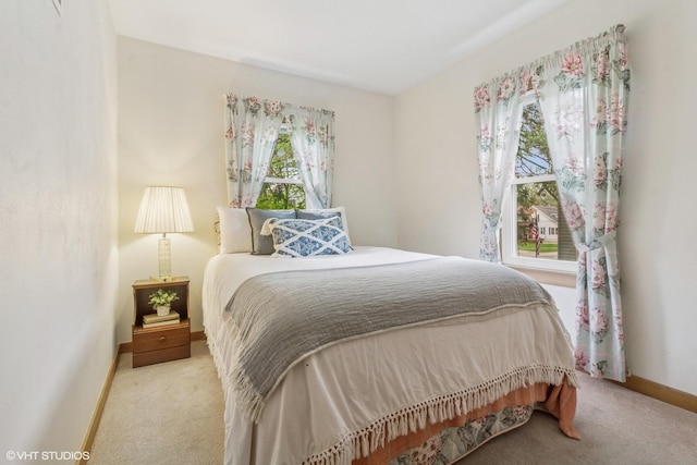 carpeted bedroom featuring baseboards