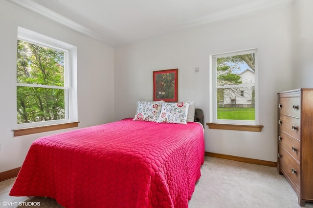 bedroom featuring carpet and baseboards