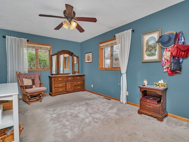 sitting room featuring visible vents, carpet flooring, baseboards, and ceiling fan