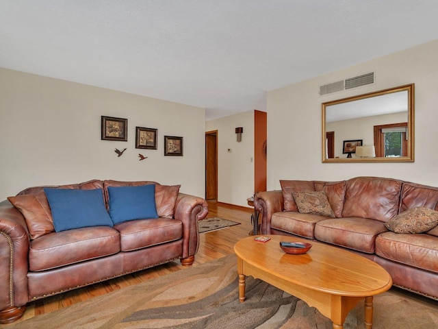 living area featuring wood finished floors and visible vents