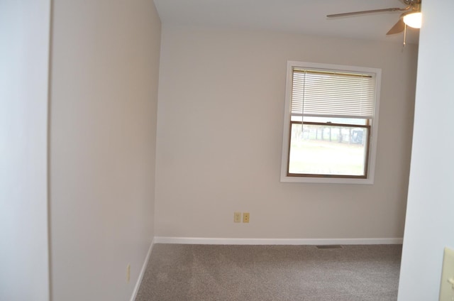 empty room featuring baseboards, a ceiling fan, and carpet