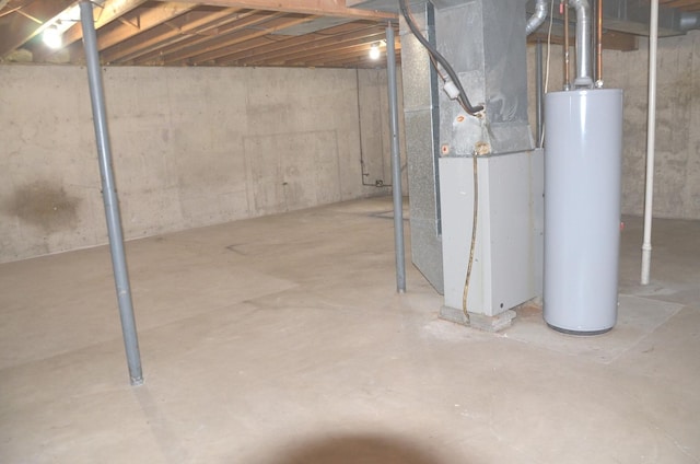 unfinished below grade area featuring water heater