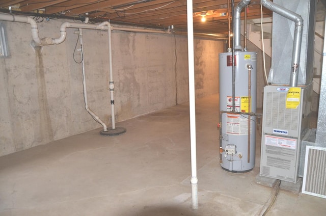 unfinished below grade area featuring water heater