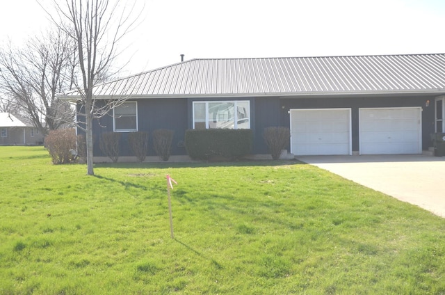 single story home with a garage, a front yard, metal roof, and concrete driveway